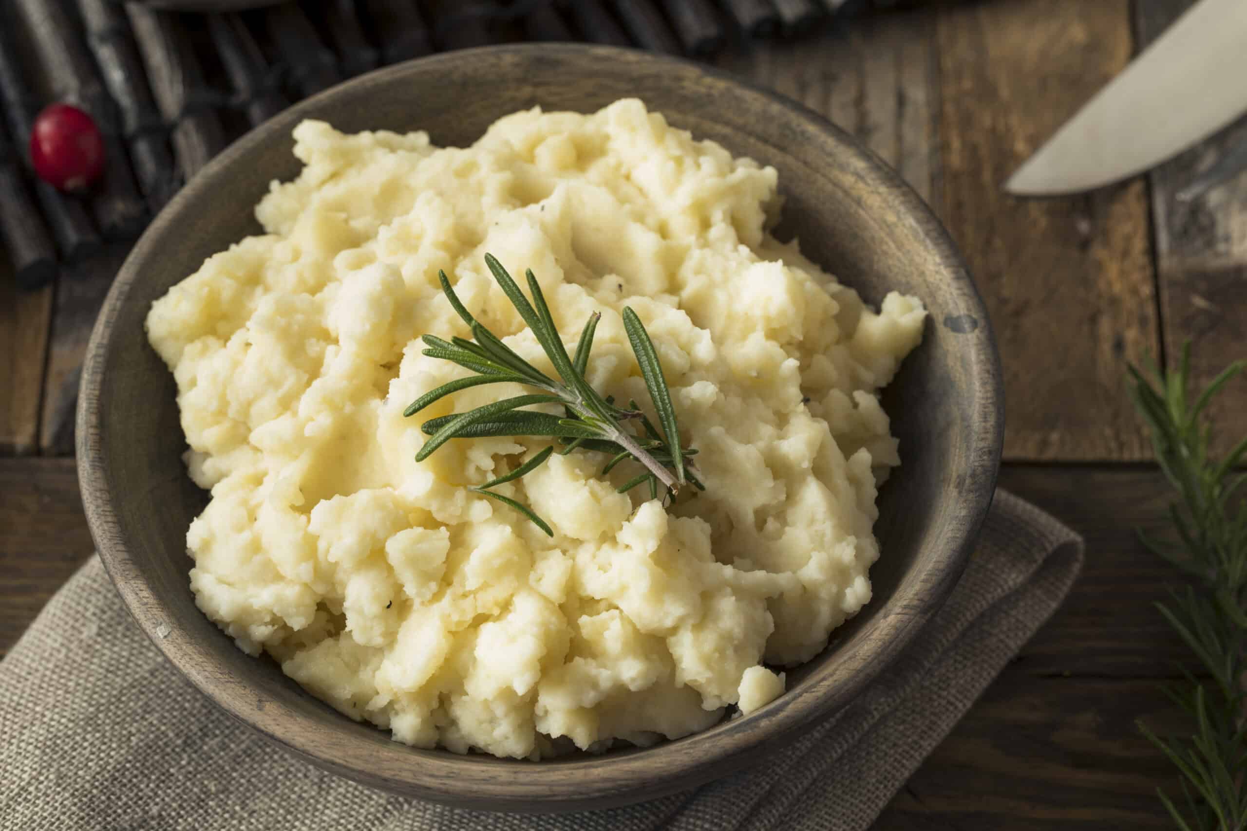 Bowl of homemade mashed potatoes on a Thanksgiving table